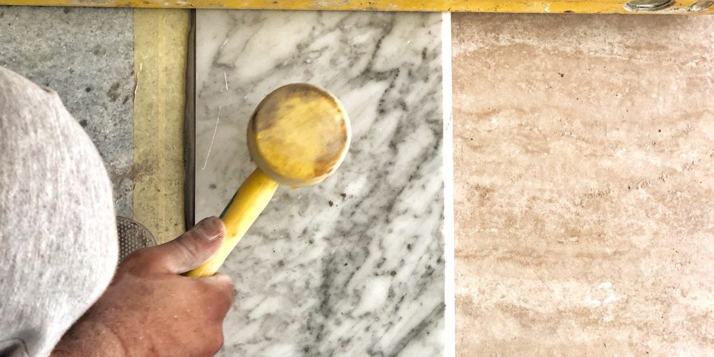 construction-construction-worker-laying-a-marble-d-Y26SV27